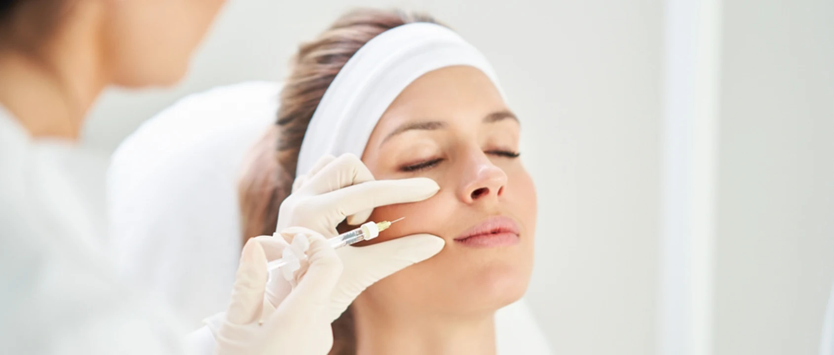 beautiful woman receiving a facial injection